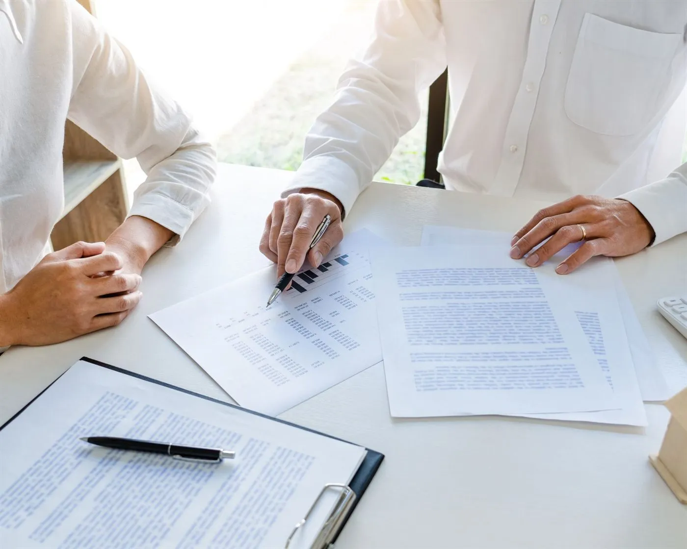 Two professionals reviewing documents together at a desk