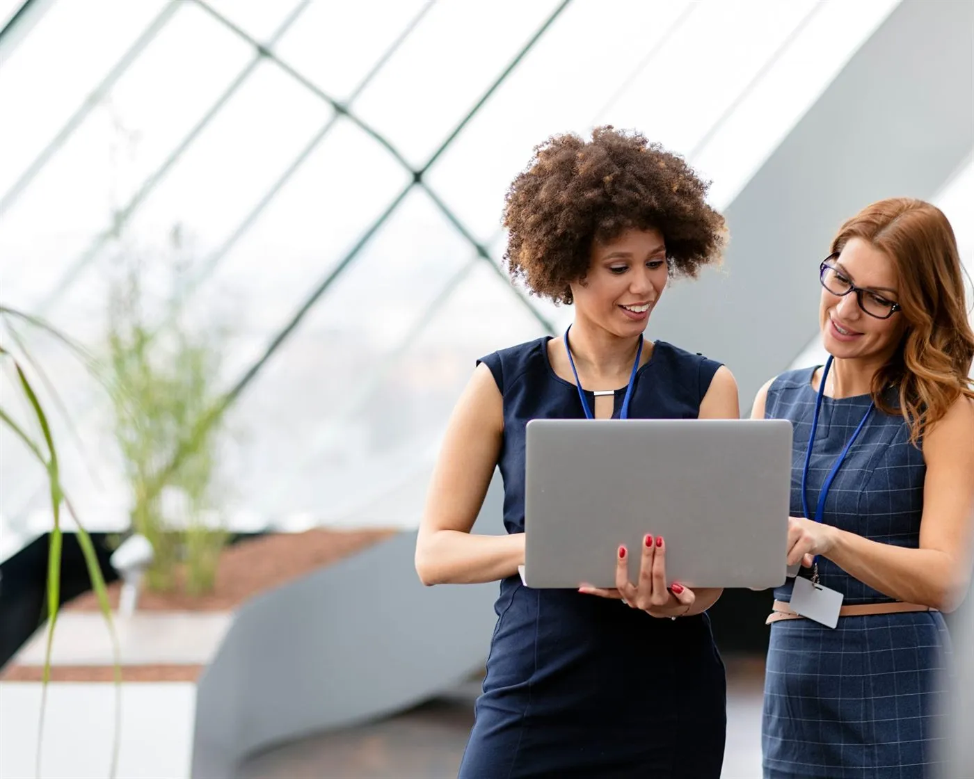 Two real estate colleagues reviewing work on a laptop