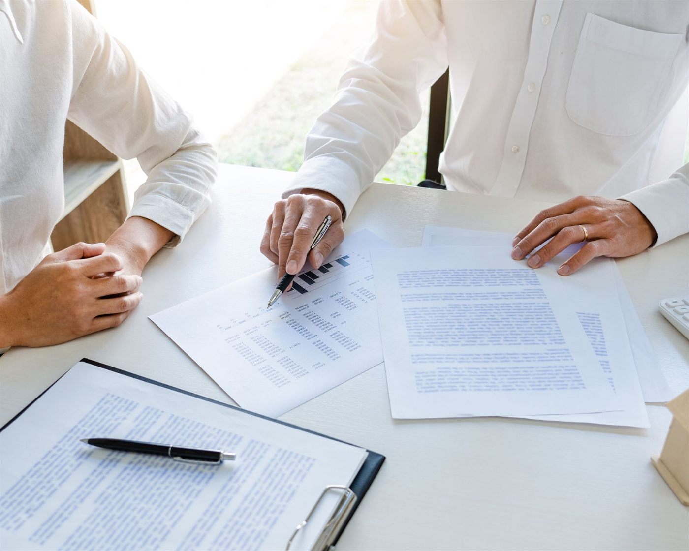 Two professionals reviewing documents together at a desk