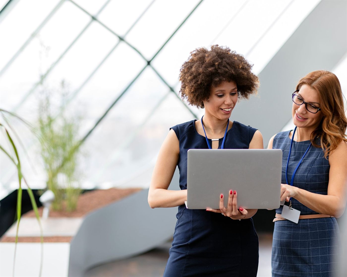 Two real estate colleagues reviewing work on a laptop